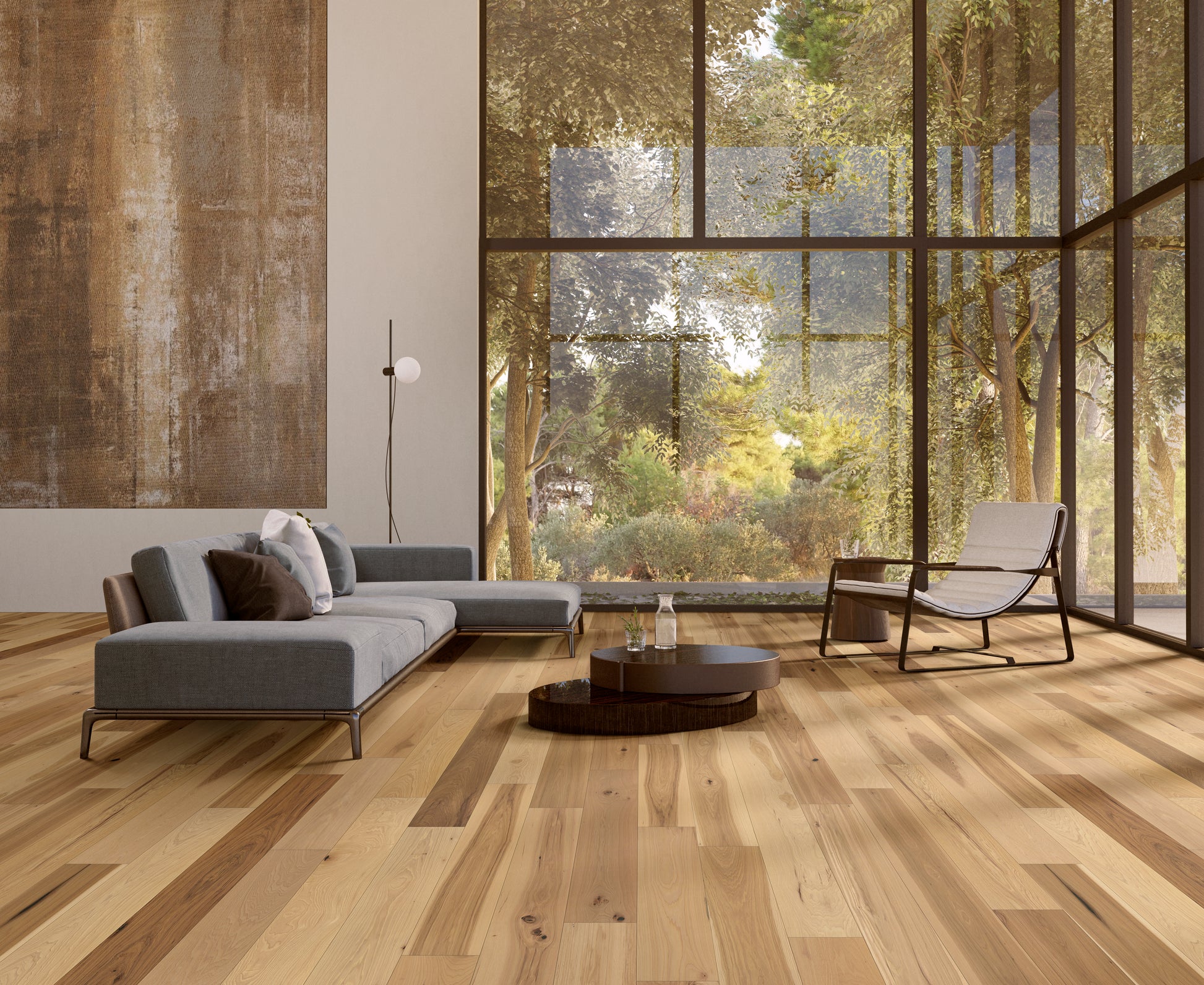 Modern living room with wooden flooring, gray sofa, and large windows.